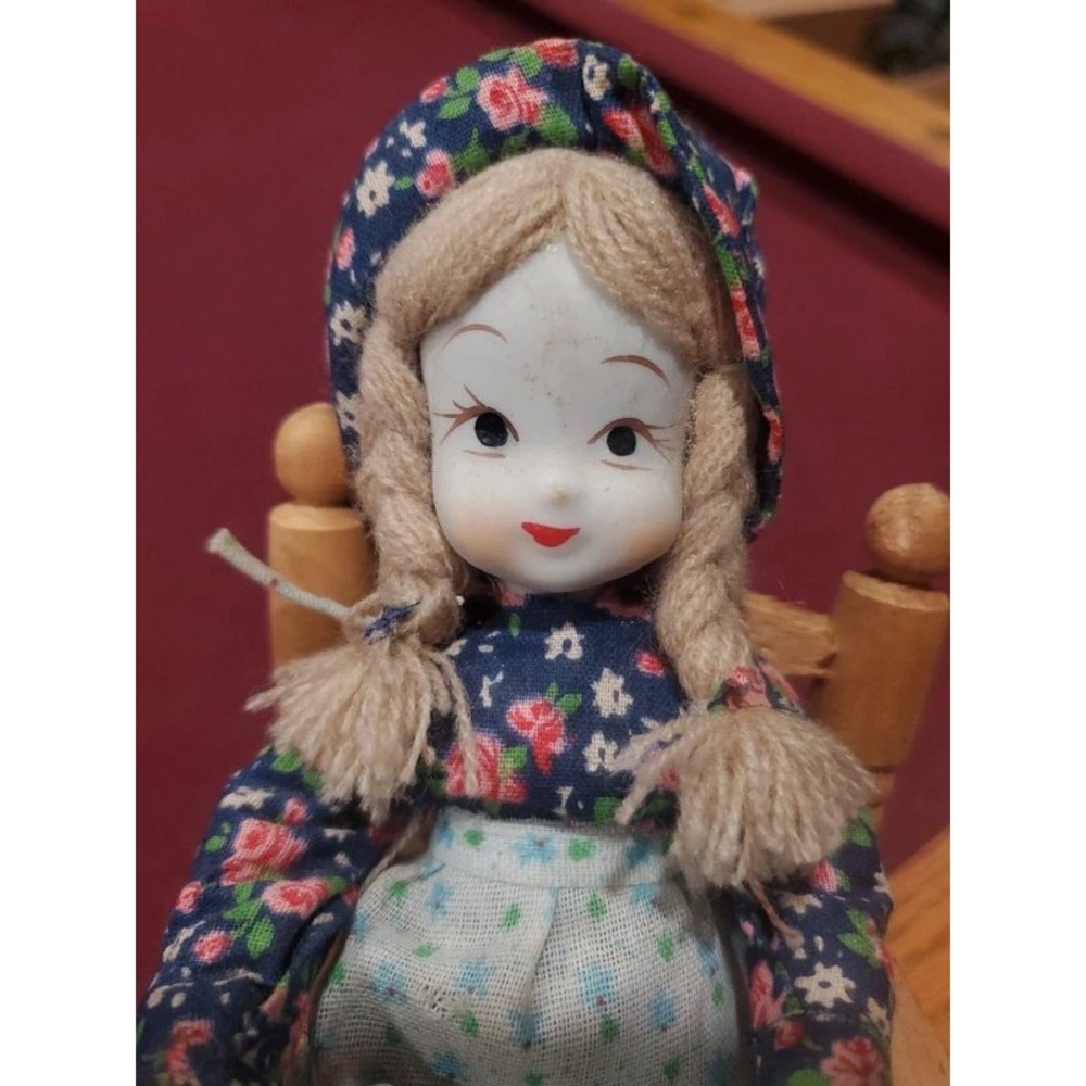 Vintage Porcelain Doll with Yarn Braids Floral Dress and Wooden Rocking Chair